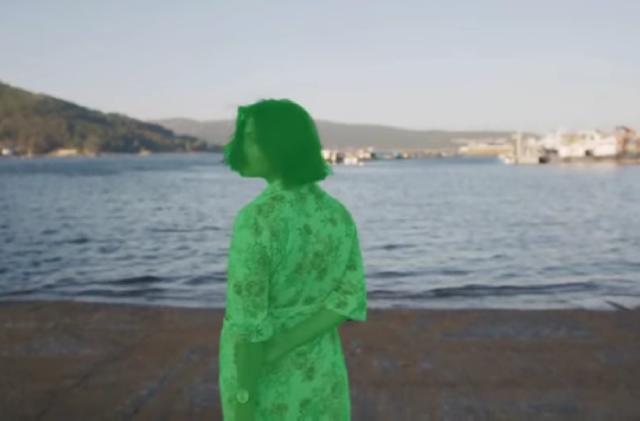 A green screen mask over a person in Runway's AI-powered content creation suite. A seaside scene is in the background.