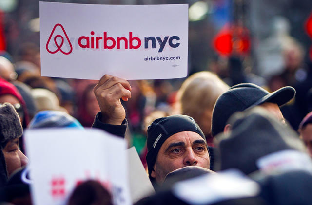 FILE — Supporters of Airbnb hold a rally outside City Hall in New York, Jan. 20, 2015. A New York judge on Tuesday, Aug. 8, 2023 dismissed lawsuits filed by Airbnb and three hosts over New York City's rules for short-term rentals, saying the restrictions are “entirely rational.” (AP Photo/Bebeto Matthews, File)