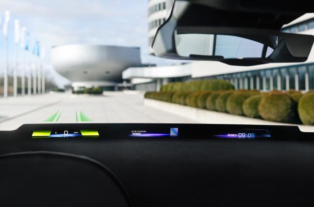 the BMW Panoramic Vision on display while driving down a road. 
