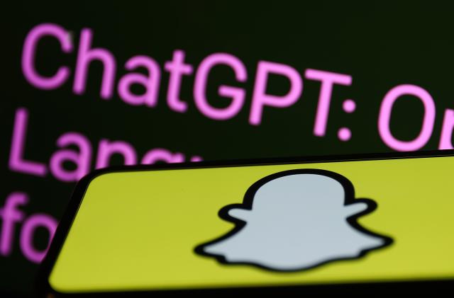 OpenAI ChatGPT website displayed on a laptop screen and Snapchat logo displayed on a phone screen are seen in this illustration photo taken in Krakow, Poland on February 27, 2023. (Photo by Jakub Porzycki/NurPhoto via Getty Images)