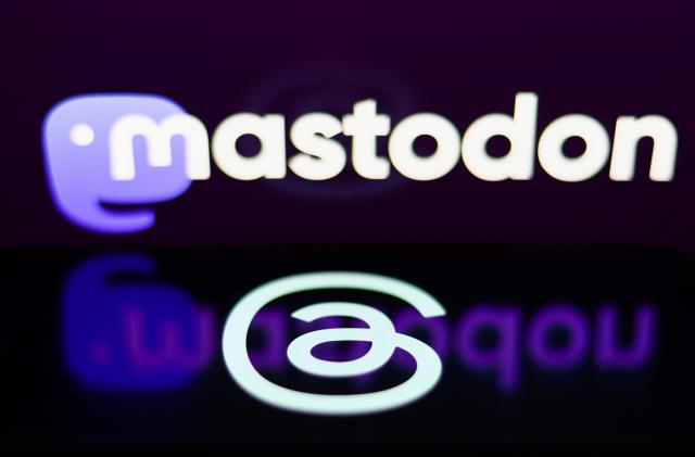 Mastodon logo displayed on a laptop screen and Threads logo displayed on a phone screen are seen in this illustration photo taken in Krakow, Poland on July 8, 2023. (Photo by Jakub Porzycki/NurPhoto via Getty Images)