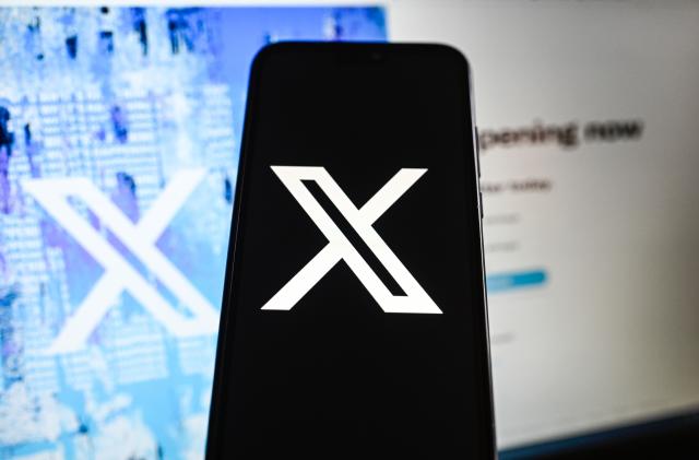 POLAND - 2023/07/28: In this photo illustration a New Twiiter logo (X) is displayed on a smartphone with Twitter website in the background. (Photo Illustration by Omar Marques/SOPA Images/LightRocket via Getty Images)
