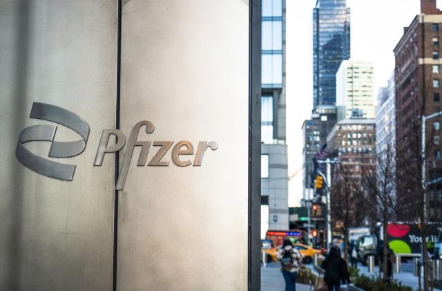 Pfizer logo on the wall by the building\'s main entrance. Pfizer\'s is the largest pharmaceutical company in the world.