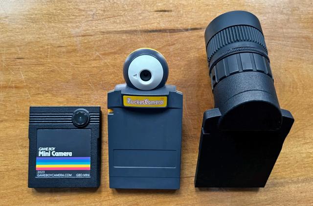Game Boy Mini Cera next to original camera and a large lens. 
