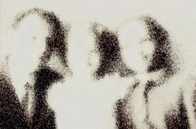 A faded family photo showing three people.