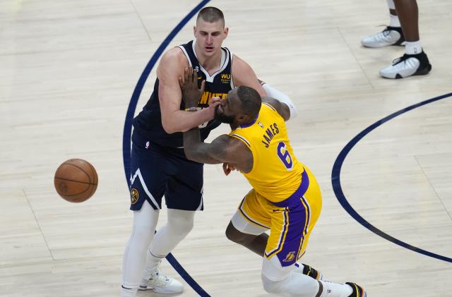 Los Angeles Lakers forward LeBron James (6) collides with Denver Nuggets center Nikola Jokic (15) during the second half of Game 2 of the NBA basketball Western Conference Finals series, Thursday, May 18, 2023, in Denver. (AP Photo/David Zalubowski)