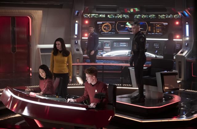 L-R Rong Fu as Mitchell, Rebecca Romijn as Una, Ethan Peck as Spock and Anson Mount as Capt. Pike in Star Trek: Strange New Worlds streaming on Paramount+, 2023. Photo Credit: Michael Gibson/Paramount+