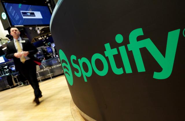 FILE - In this Tuesday, April 3, 2018 file photo, a trading post sports the Spotify logo on the floor of the New York Stock Exchange. U.K. regulators are stepping up scrutiny of the country's music streaming market to see whether there's enough competition, after lawmakers outlined concerns that big online major platforms like Spotify may be too dominant. The U.K.'s competition watchdog said Tuesday, Oct. 19 2021 it will carry out a “market study” to assess whether fresh measures are needed to improve streaming competition. (AP Photo/Richard Drew, File)