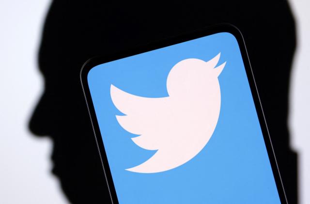 Twitter logo and Elon Musk silhouette are seen in this illustration taken, December 19, 2022. REUTERS/Dado Ruvic/Illustration
