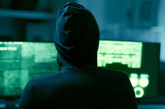 Hacker, IT and person with code on computer, programming and phishing scam with malware or virus. Hacking, system glitch and cloud computing error in dark room, cyber crime and cybersecurity fail