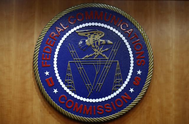 The seal of the Federal Communications Commission (FCC) is seen before an FCC meeting to vote on net neutrality in Washington, Thursday, Dec. 14, 2017. (AP Photo/Jacquelyn Martin)